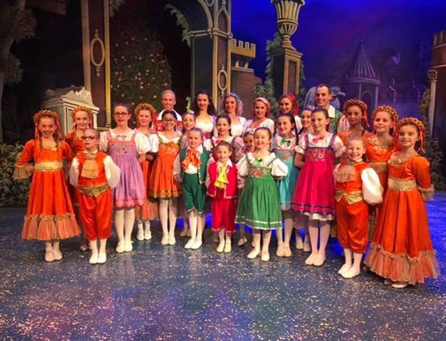 Children dressed in colourful clothes on the stage